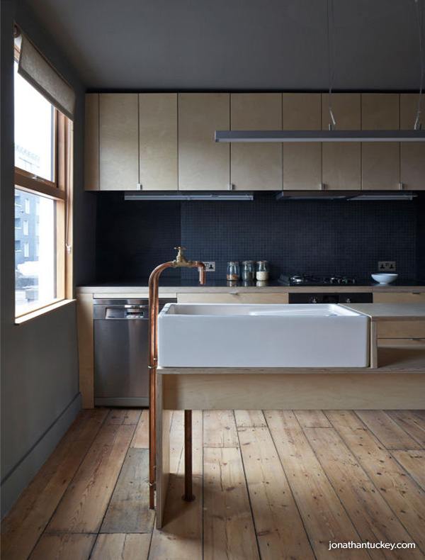 Pale wood kitchen with copper exposed pipe tapware and butler sink